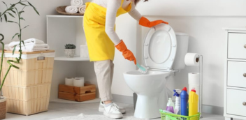 Cleaner scrubbing a bathroom sink